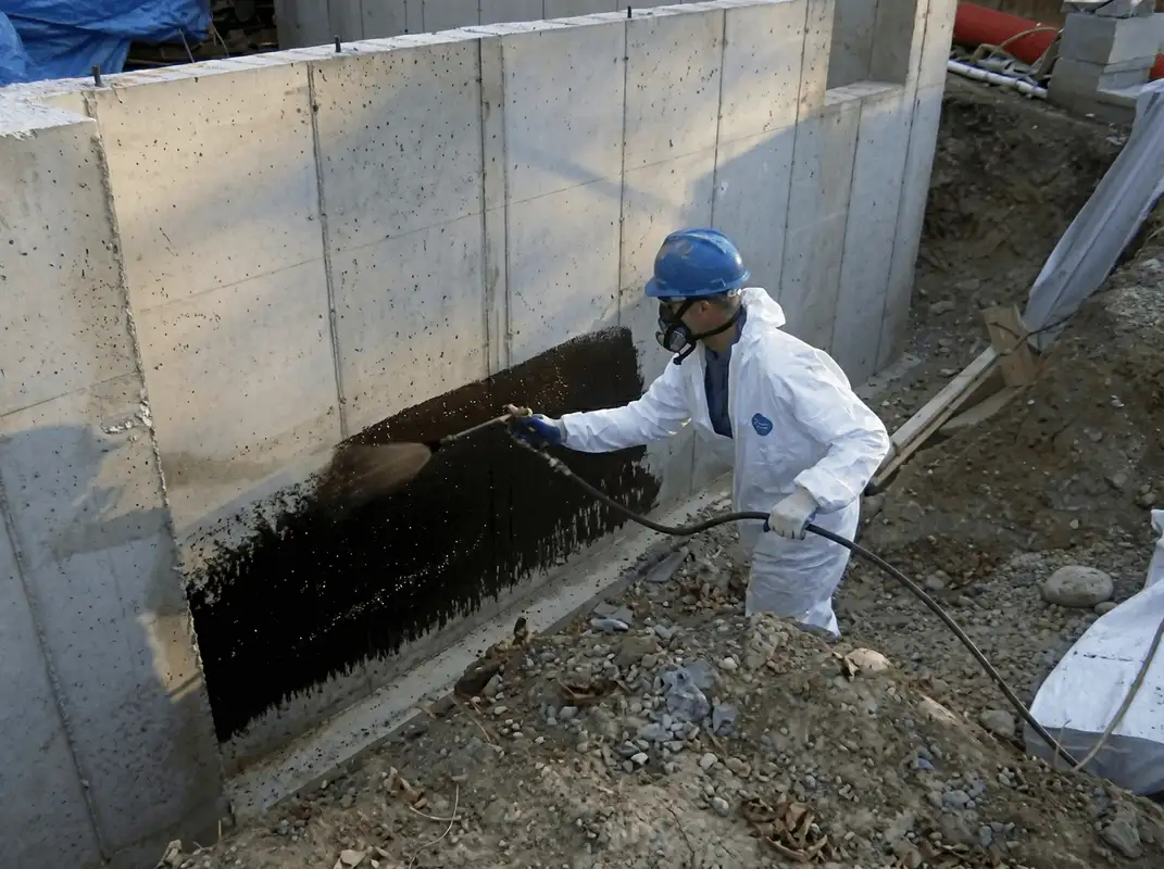 Professional waterproofing the exterior walls of the basement in Cedar Rapids, IA