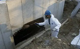 Professional waterproofing the exterior walls of the basement in Cedar Rapids, IA