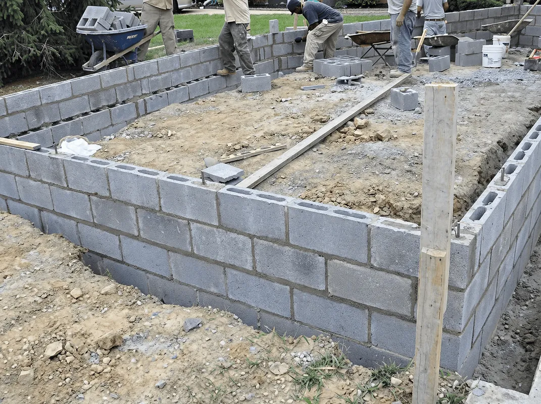 Professionals building a foundation with blocks in Cedar Rapids, IA