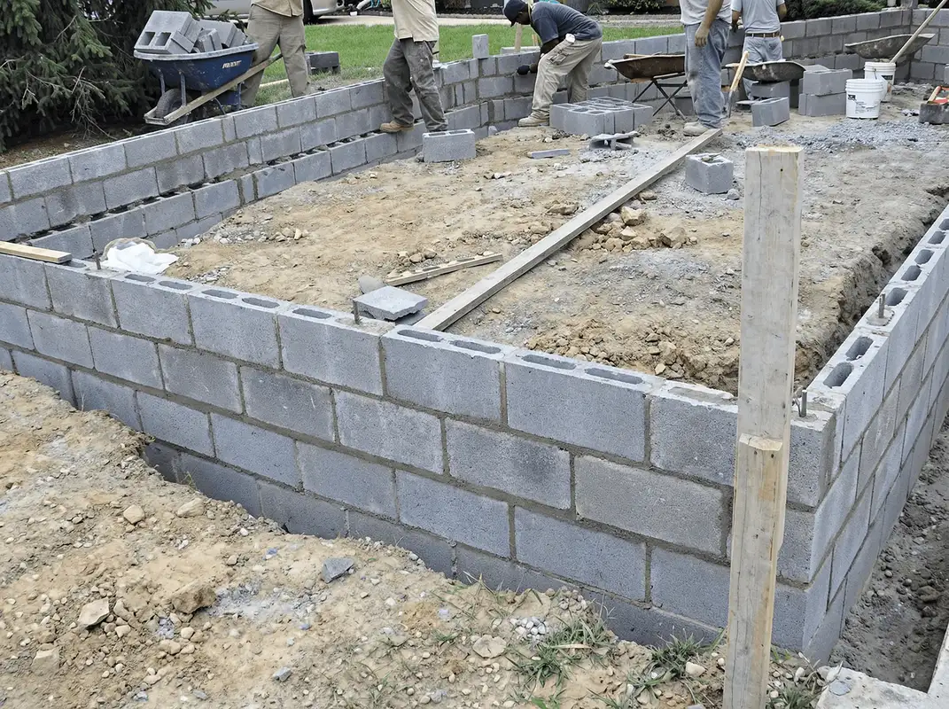 Professionals building a foundation with blocks in Cedar Rapids, IA