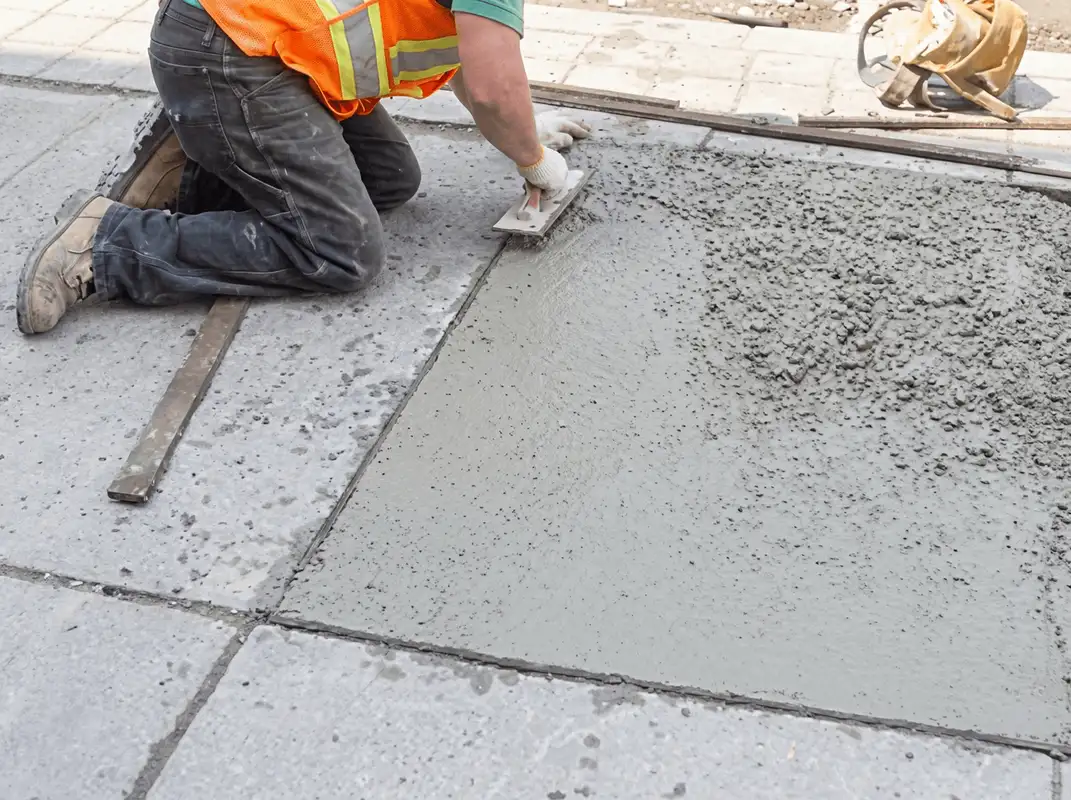 Professional repairing a concrete floor in Cedar Rapids, IA