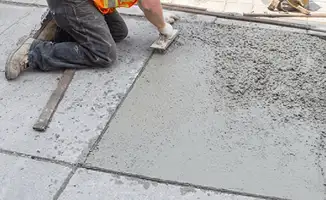 Professional repairing a concrete floor in Cedar Rapids, IA