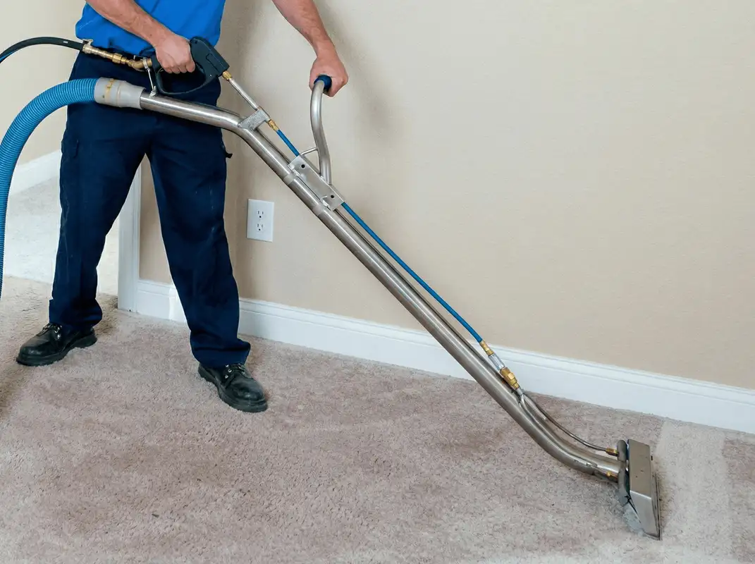 Professional operating a liquid removal machine on a carpeted floor in Cedar Rapids, IA